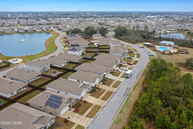 drone / aerial view featuring a water view and a residential view