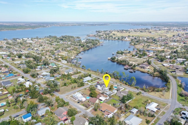 birds eye view of property featuring a water view and a residential view