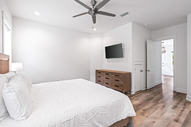 bedroom with recessed lighting, visible vents, ceiling fan, wood finished floors, and baseboards