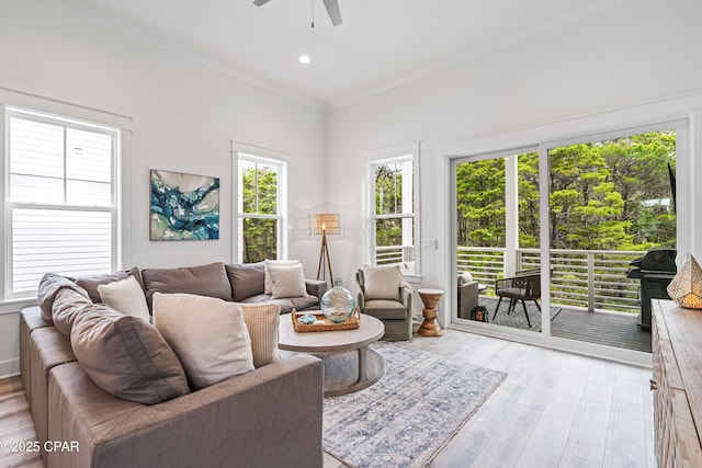 living area with light wood finished floors, ornamental molding, a ceiling fan, and recessed lighting