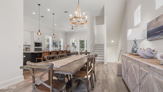 150 Grande Pointe Cir, Inlet Beach, FL 32461 - dining area featuring light wood-type flooring, a chandelier, ceiling fan, a towering ceiling, and recessed lighting
