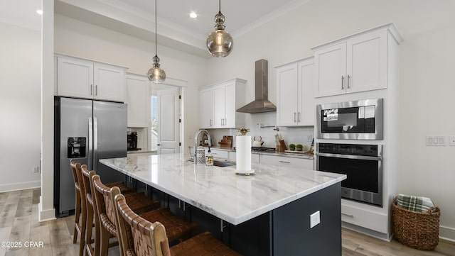 150 Grande Pointe Cir, Inlet Beach, FL 32461 - kitchen with appliances with stainless steel finishes, wall chimney exhaust hood, tasteful backsplash, white cabinetry, and light stone counters