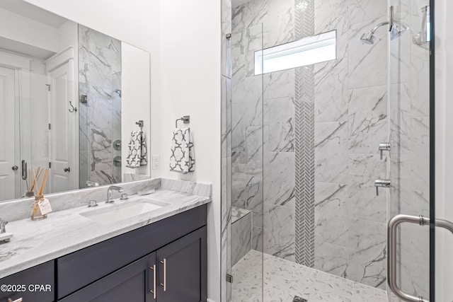 bathroom featuring a shower stall and vanity