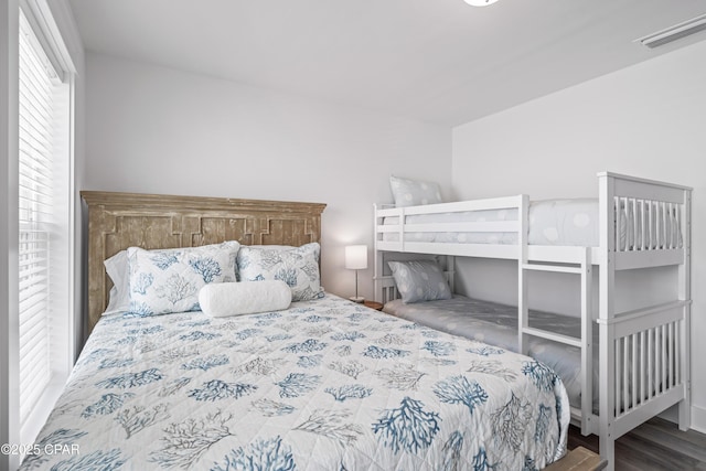 bedroom with visible vents and wood finished floors