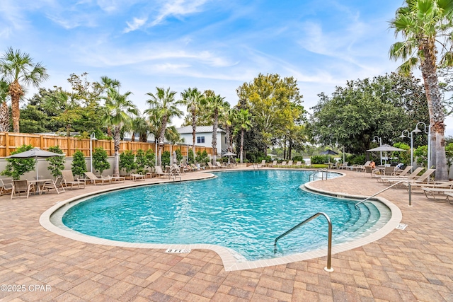 pool featuring fence and a patio