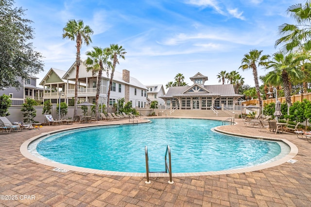 pool featuring fence and a patio