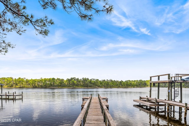 dock area with a water view and a view of trees