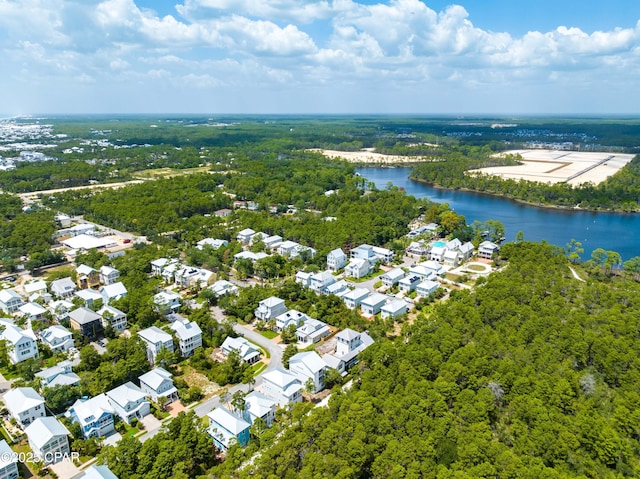 bird's eye view with a residential view, a water view, and a wooded view