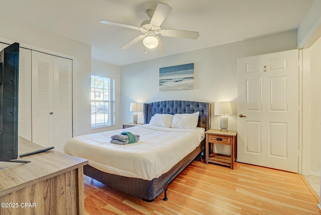 bedroom with a closet, light wood finished floors, and a ceiling fan
