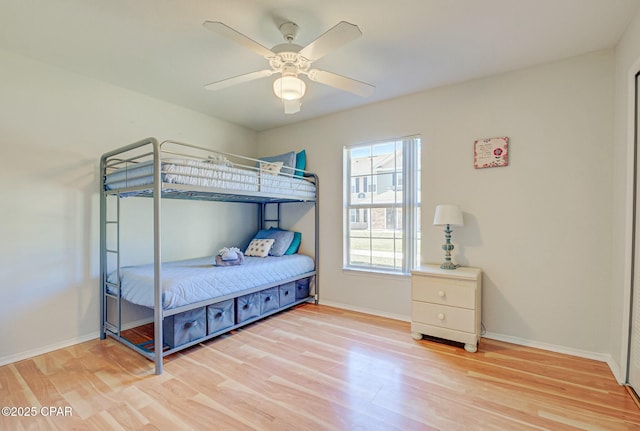 bedroom with light wood-style floors and baseboards