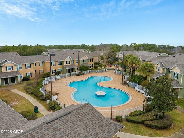 community pool with a residential view and fence
