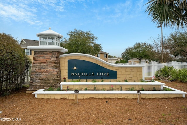 community sign featuring fence