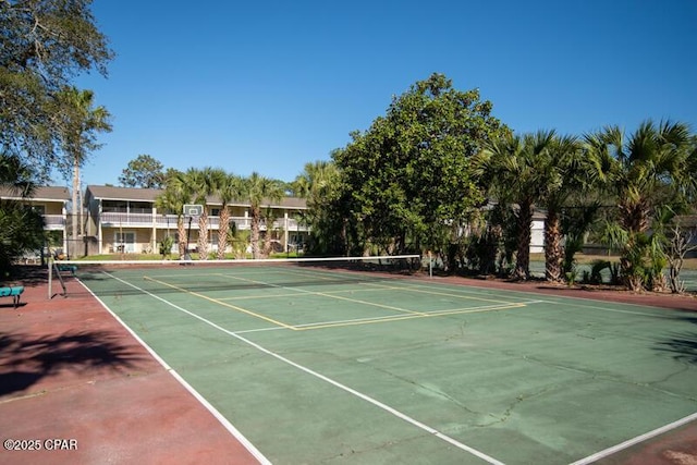 view of tennis court featuring fence