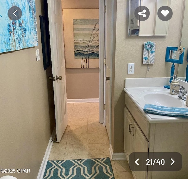 bathroom with tile patterned flooring, vanity, and baseboards