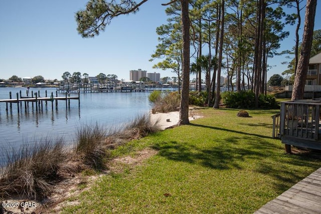 dock area with a yard and a water view