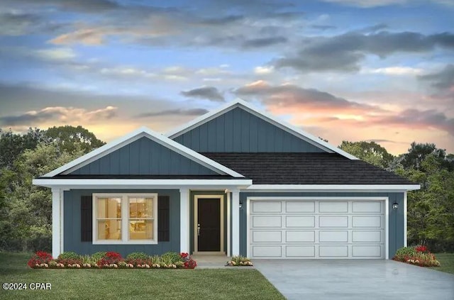 view of front of house featuring a garage, concrete driveway, roof with shingles, a front lawn, and board and batten siding