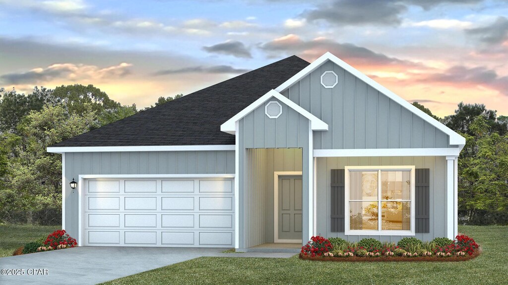 4866 Forest Dunes Dr, Panama City, FL 32404 - view of front of home with a front yard, an attached garage, driveway, and roof with shingles