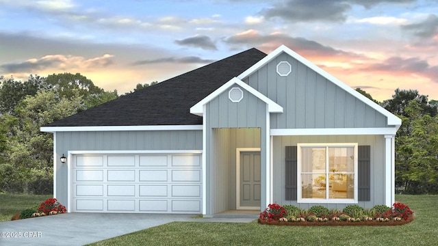 view of front of home with a front yard, an attached garage, driveway, and roof with shingles