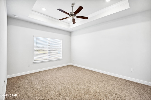 carpeted empty room featuring crown molding, baseboards, a tray ceiling, recessed lighting, and a ceiling fan