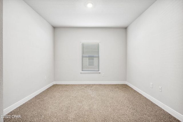 unfurnished room featuring baseboards and carpet floors