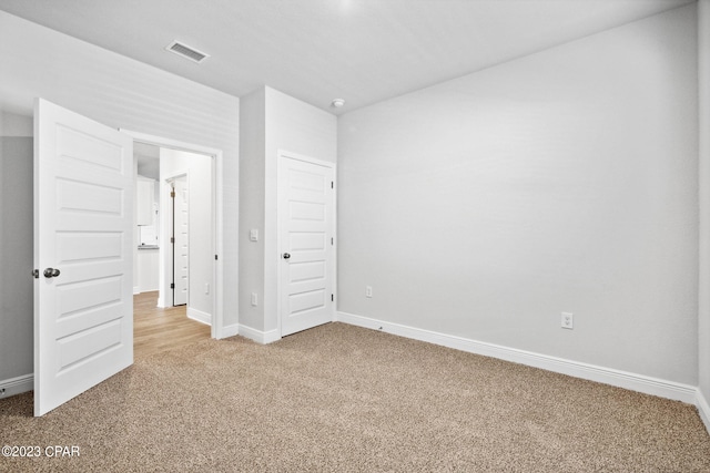 unfurnished bedroom with visible vents, baseboards, and carpet floors