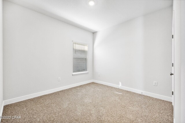 empty room with carpet flooring and baseboards