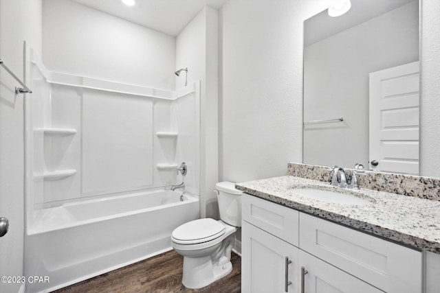 full bathroom with tub / shower combination, toilet, wood finished floors, and vanity