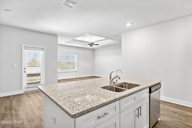 kitchen with visible vents, white cabinetry, a sink, dishwasher, and light wood-type flooring