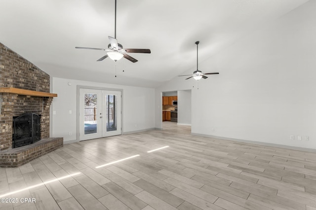 7577 Kelsey Dr, Panama City, FL 32404 - unfurnished living room with wood finish floors, a fireplace, a ceiling fan, baseboards, and french doors