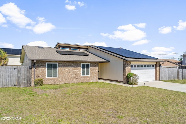 view of front facade with fence, a front lawn, and brick siding