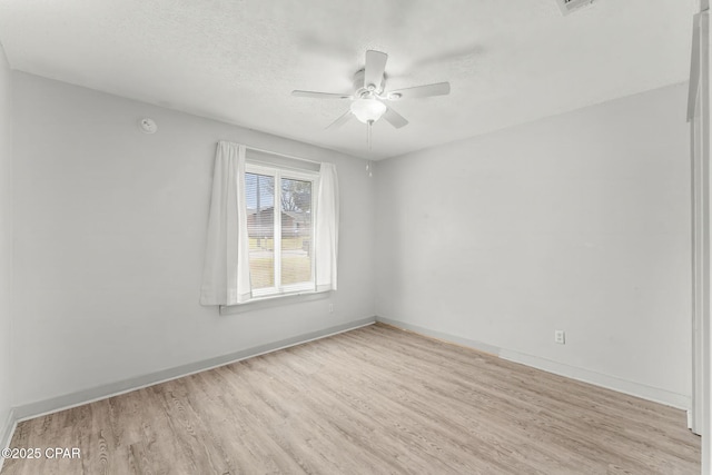 7577 Kelsey Dr, Panama City, FL 32404 - unfurnished room with a textured ceiling, wood finished floors, a ceiling fan, and baseboards