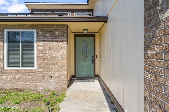 property entrance featuring brick siding