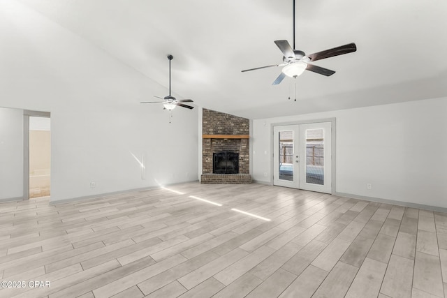 7577 Kelsey Dr, Panama City, FL 32404 - unfurnished living room with light wood finished floors, ceiling fan, french doors, a brick fireplace, and high vaulted ceiling