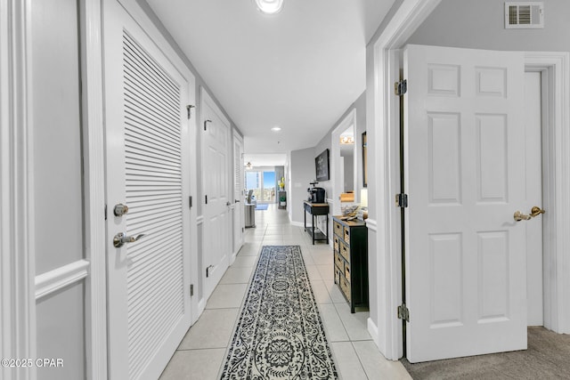 hallway featuring recessed lighting, visible vents, and light tile patterned flooring