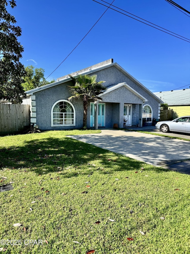 6121 Orange Plz, Panama City, FL 32408 - view of front of house featuring a front yard, stucco siding, and fence