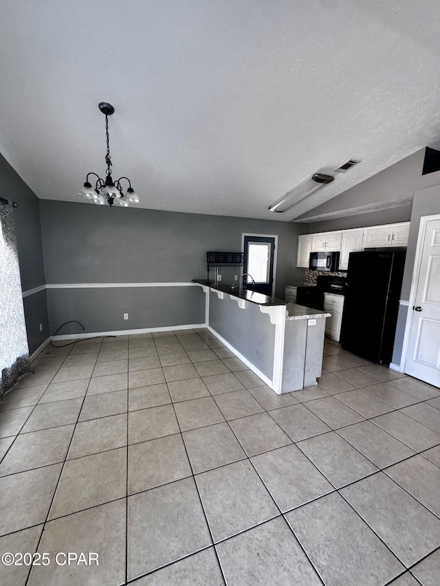 6121 Orange Plz, Panama City, FL 32408 - kitchen featuring vaulted ceiling, an inviting chandelier, light tile patterned flooring, white cabinets, and black appliances