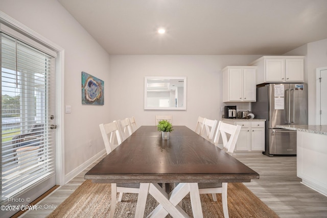 dining space with plenty of natural light, light wood-style flooring, baseboards, and recessed lighting