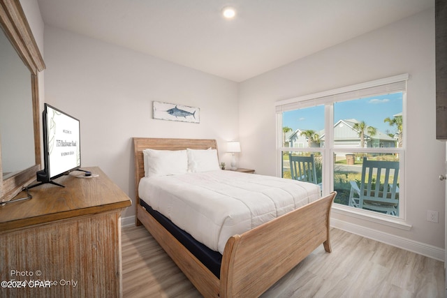 bedroom featuring baseboards and light wood-style floors