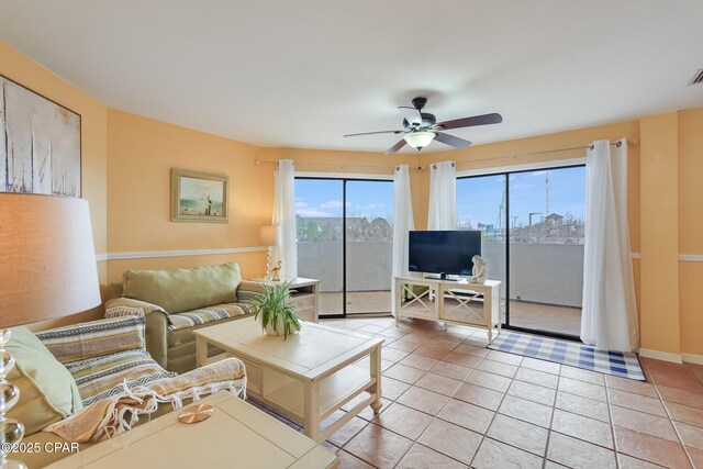 8730 Thomas Dr Unit 1201-B, Panama City Beach, FL 32408 - living area featuring light tile patterned flooring, baseboards, and ceiling fan