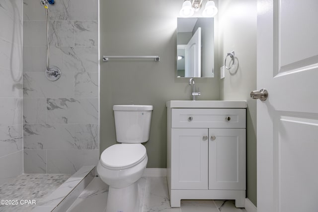 1705 Lake Ave, Panama City, FL 32401 - bathroom featuring marble finish floors, a tile shower, toilet, vanity, and baseboards