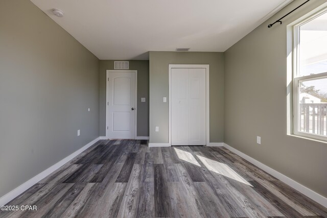 1705 Lake Ave, Panama City, FL 32401 - unfurnished room with dark wood finished floors, a smoke detector, and baseboards