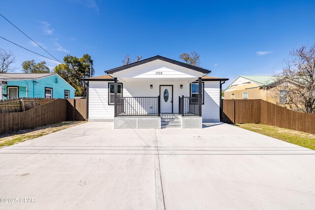 1705 Lake Ave, Panama City, FL 32401 - view of front facade featuring a porch, concrete driveway, and fence