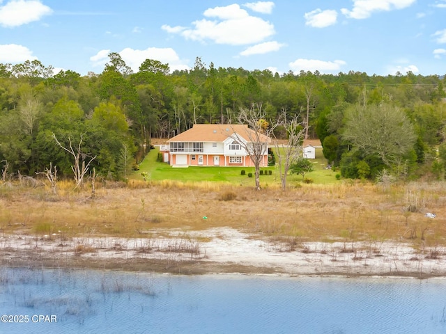 bird's eye view featuring a forest view and a water view