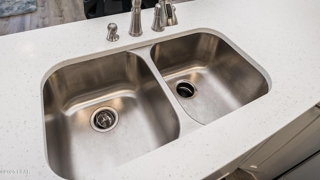 room details with a sink and light stone countertops