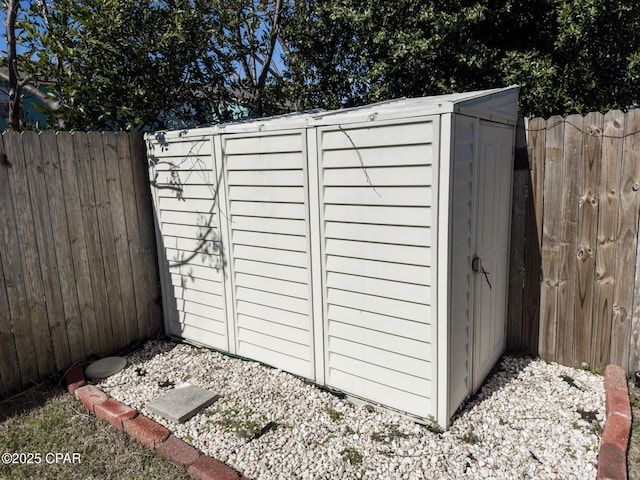 view of shed with a fenced backyard