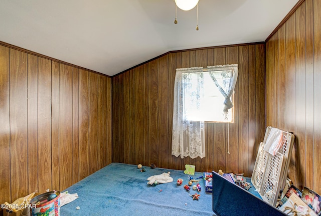 spare room featuring lofted ceiling and wood walls