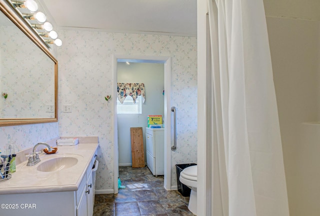 bathroom featuring baseboards, vanity, toilet, and wallpapered walls