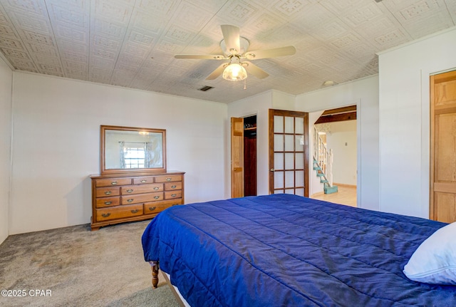 carpeted bedroom with an ornate ceiling and ceiling fan