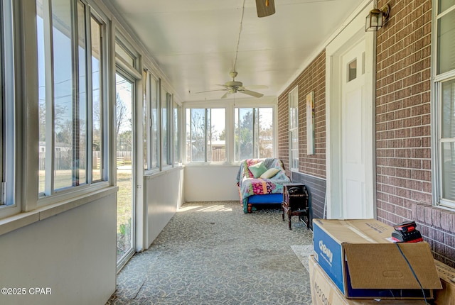 sunroom / solarium featuring a ceiling fan