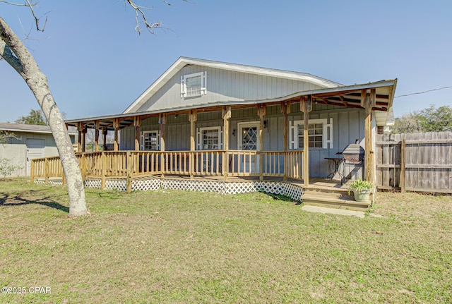 exterior space featuring fence, a porch, and a front yard